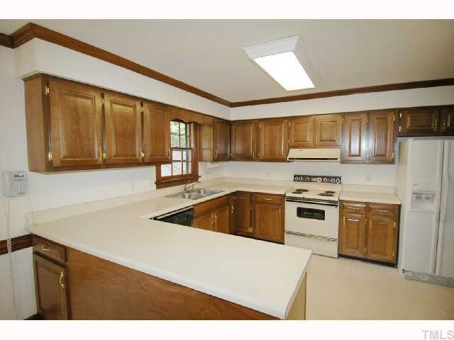8304 Mourning Dove Road Raleigh, NC 27615 - Photo 3 of 8 a kitchen with a sink a stove and cabinets