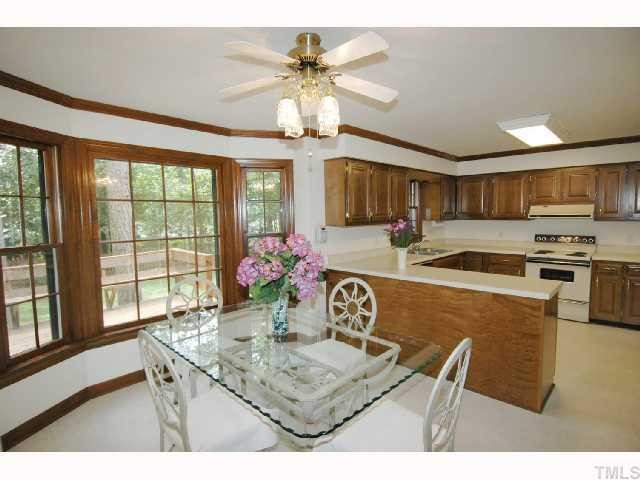 8304 Mourning Dove Road Raleigh, NC 27615 - Photo 4 of 8 a kitchen with a table and chairs in it