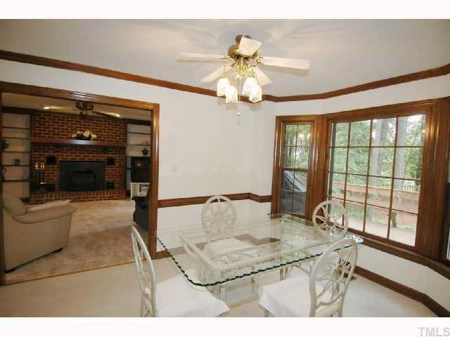 8304 Mourning Dove Road Raleigh, NC 27615 - Photo 5 of 8 a living room with furniture a flat screen tv and a large window