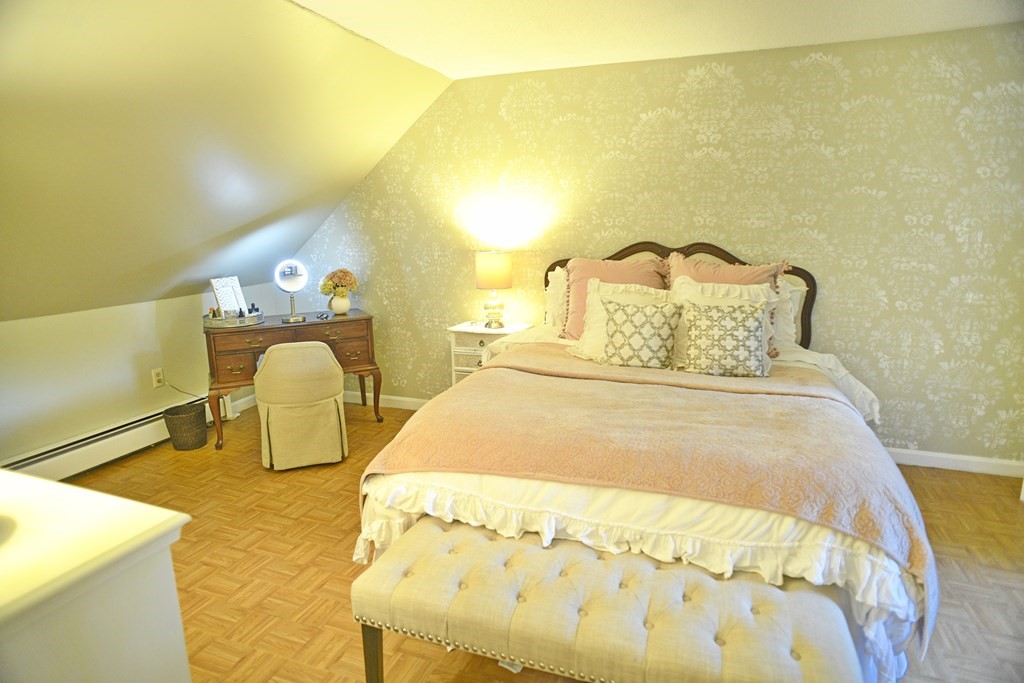 72 Heritage Drive Lowell, MA 01852 - Photo 15 of 29 a bed sitting in a bedroom next to a bathroom