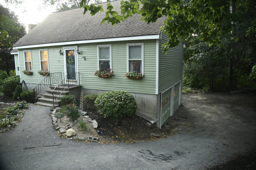 72 Heritage Drive Lowell, MA 01852 - Photo 22 of 29 a front view of a house with garden