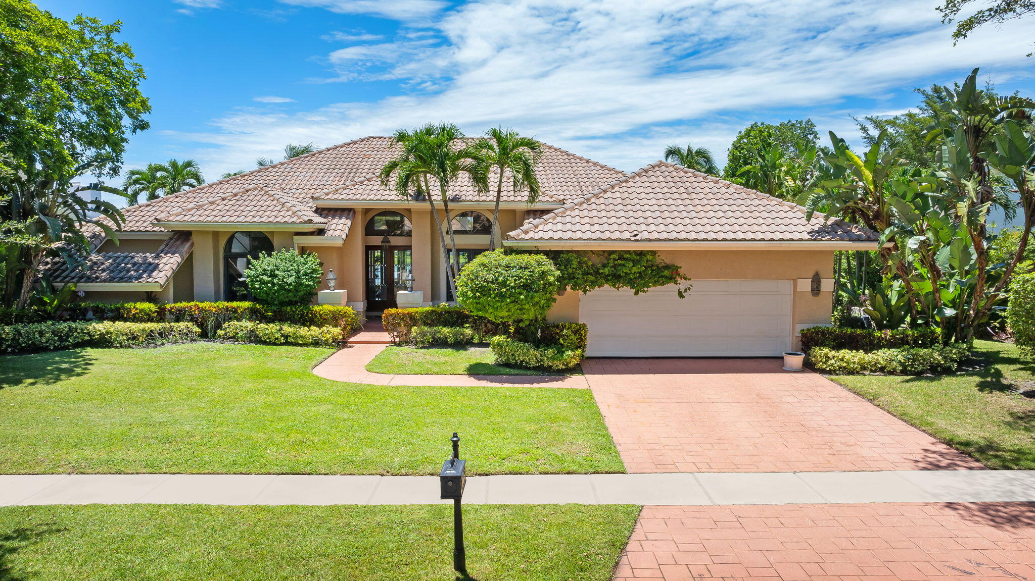 4885 Regency Court Boca Raton, FL 33434 - Photo 1 of 38 a front view of house with yard and green space