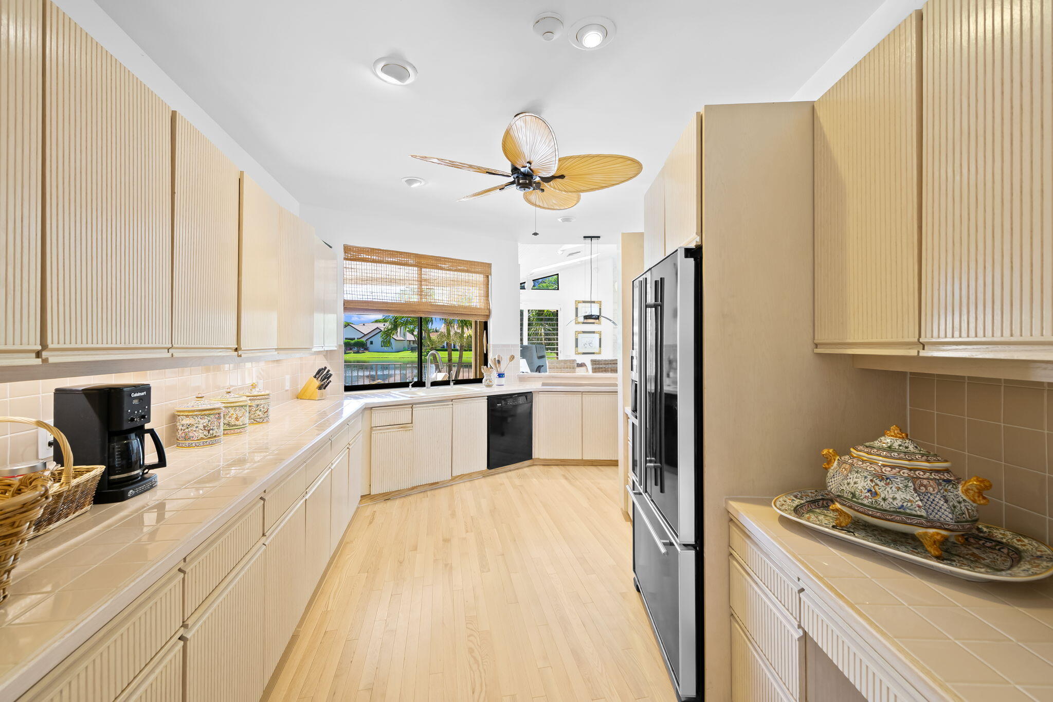 4885 Regency Court Boca Raton, FL 33434 - Photo 11 of 38 a kitchen with stainless steel appliances granite countertop a sink a stove a refrigerator and cabinets
