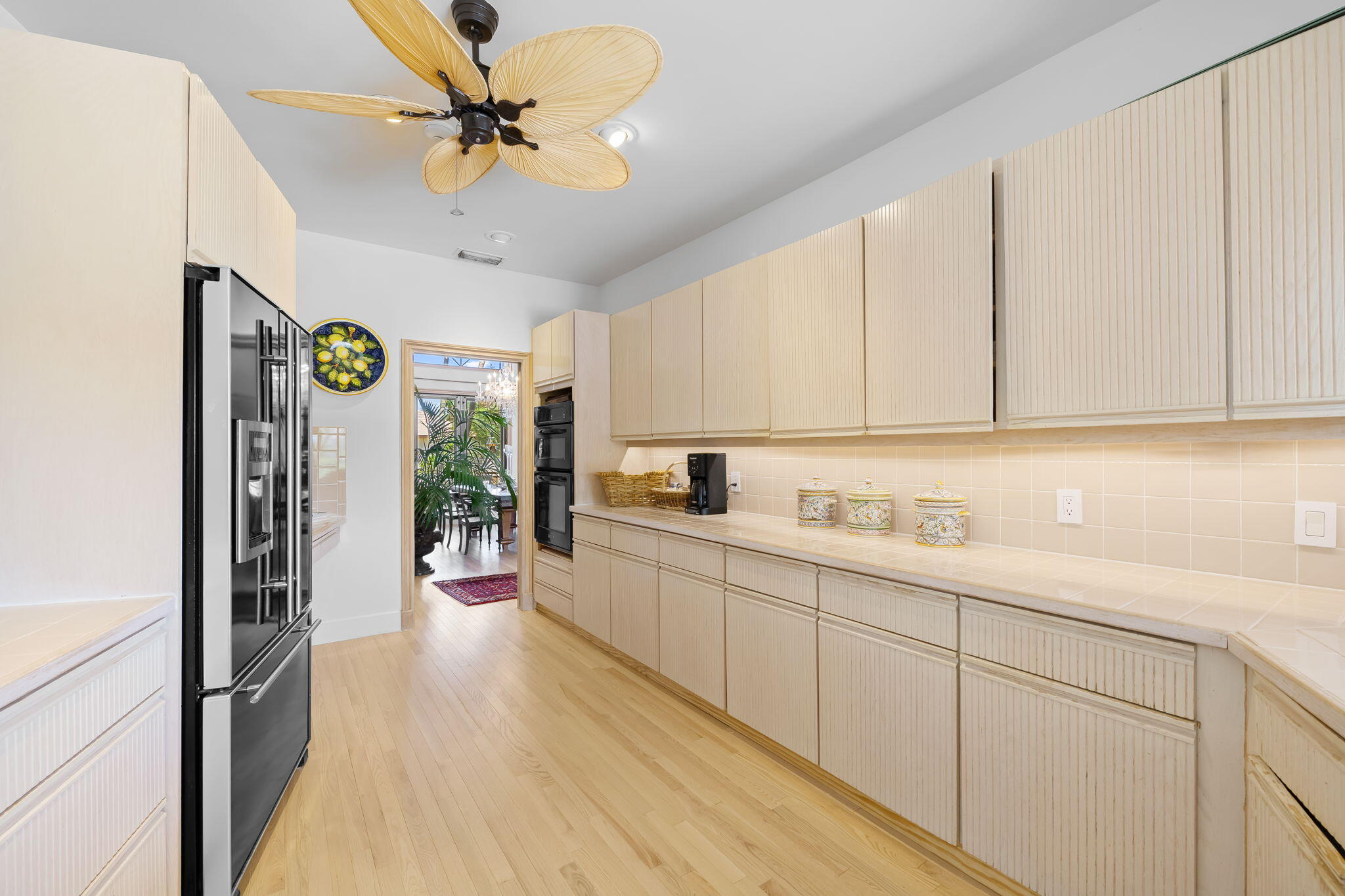 4885 Regency Court Boca Raton, FL 33434 - Photo 12 of 38 a kitchen with a sink stainless steel appliances cabinets and a counter top space