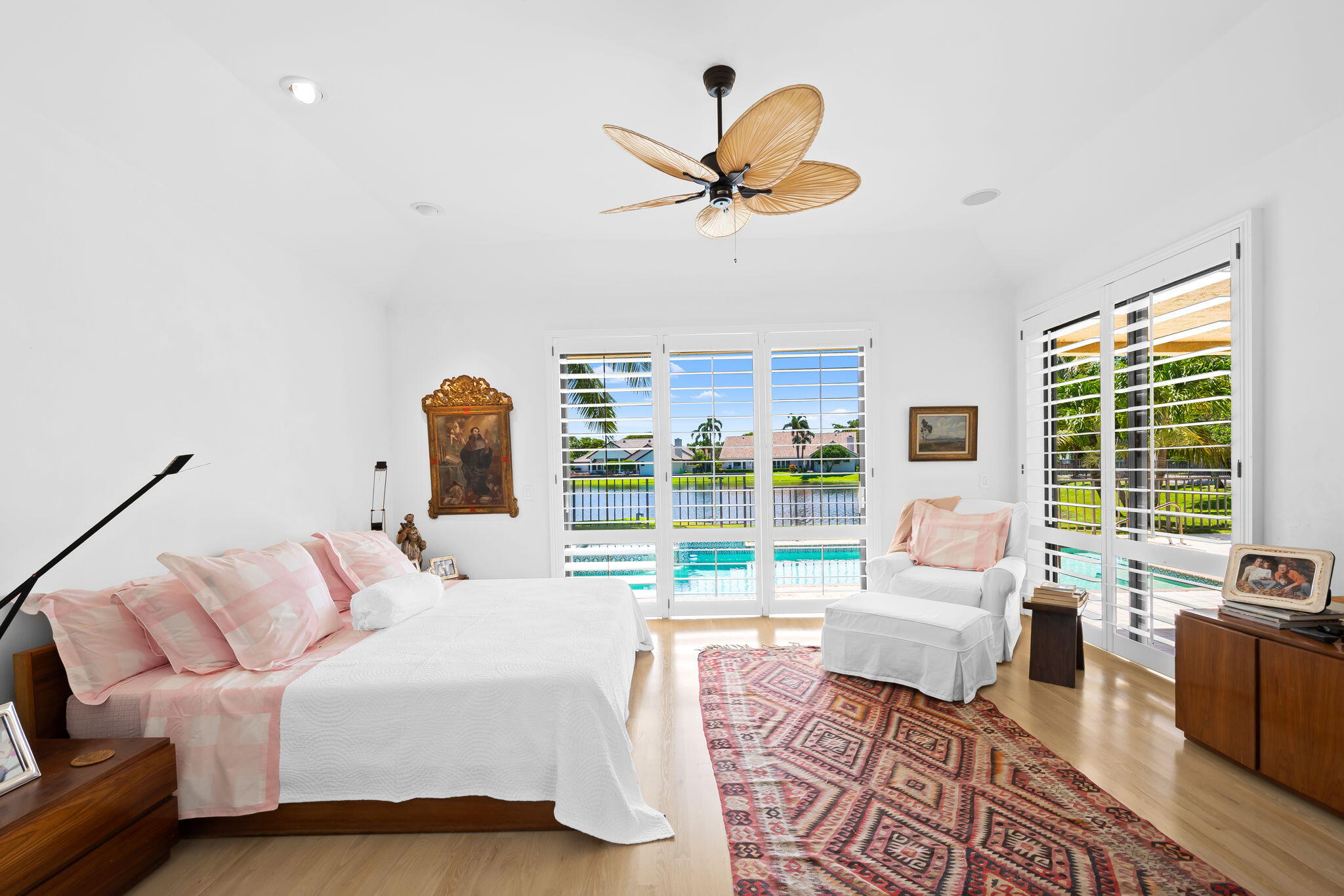 4885 Regency Court Boca Raton, FL 33434 - Photo 13 of 38 a bedroom with a large bed and a chandelier