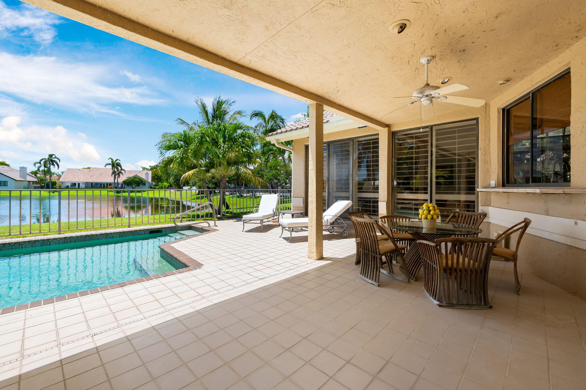 4885 Regency Court Boca Raton, FL 33434 - Photo 27 of 38 a view of a patio with a table and chairs