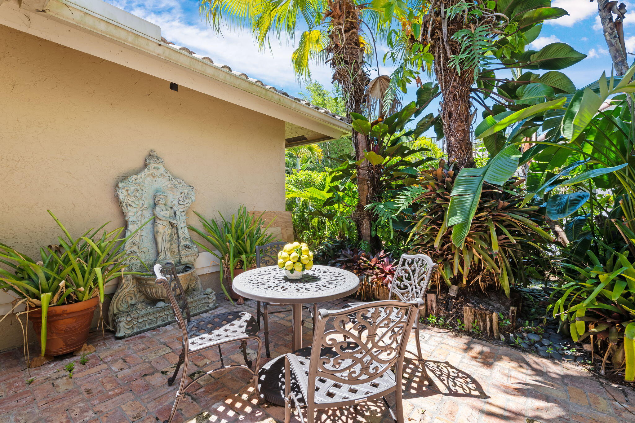 4885 Regency Court Boca Raton, FL 33434 - Photo 28 of 38 a outdoor space with a table and chairs and a potted plant
