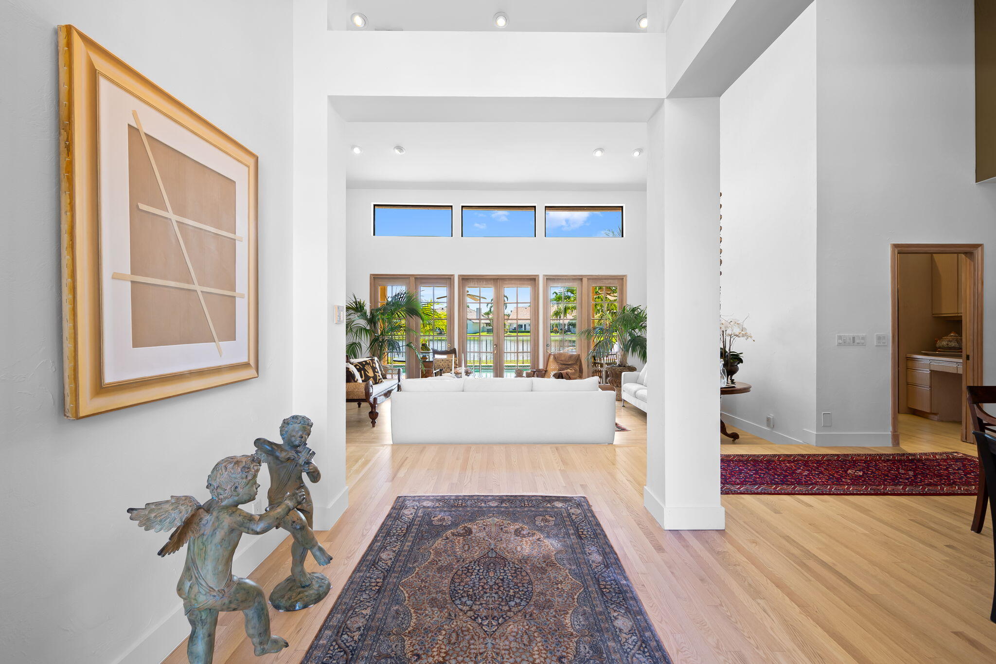 4885 Regency Court Boca Raton, FL 33434 - Photo 3 of 38 a living room with a couch and a table