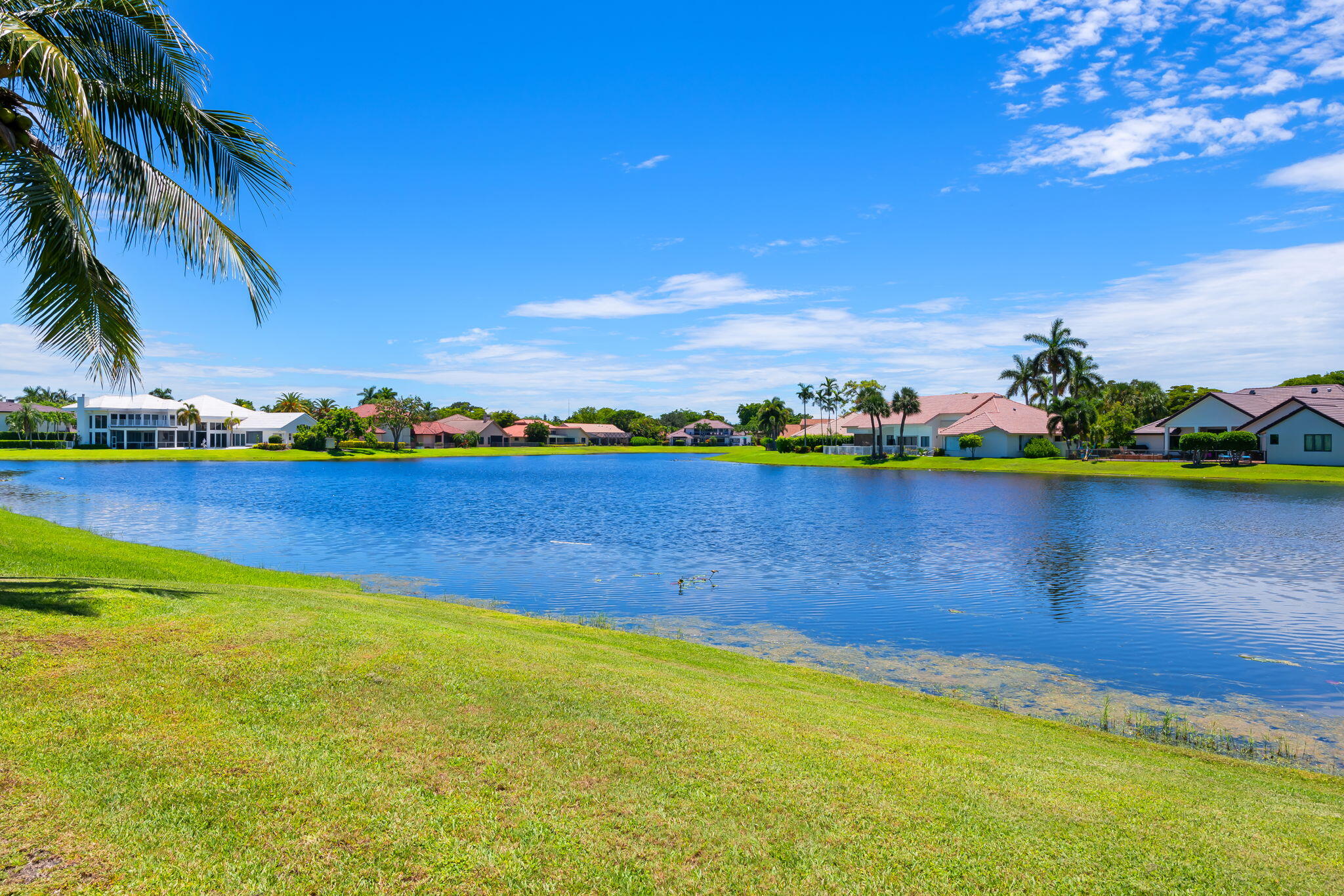 4885 Regency Court Boca Raton, FL 33434 - Photo 31 of 38 a view of a lake with houses in the back