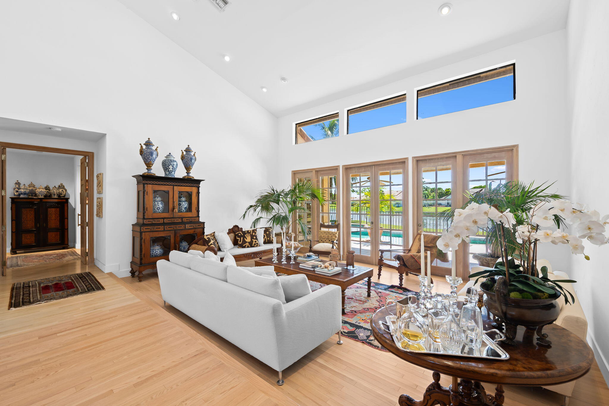 4885 Regency Court Boca Raton, FL 33434 - Photo 6 of 38 a living room with furniture large window and potted plants