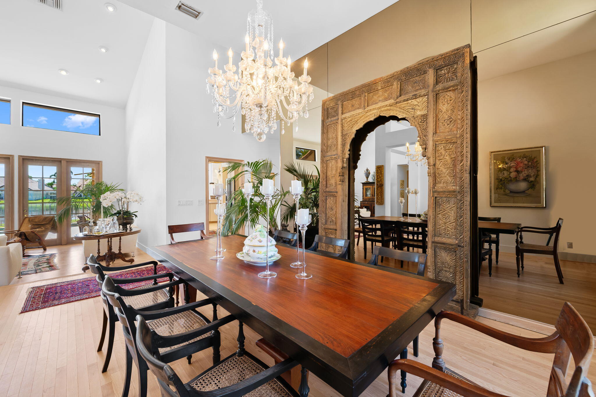 4885 Regency Court Boca Raton, FL 33434 - Photo 7 of 38 a dining room with furniture a rug and a chandelier