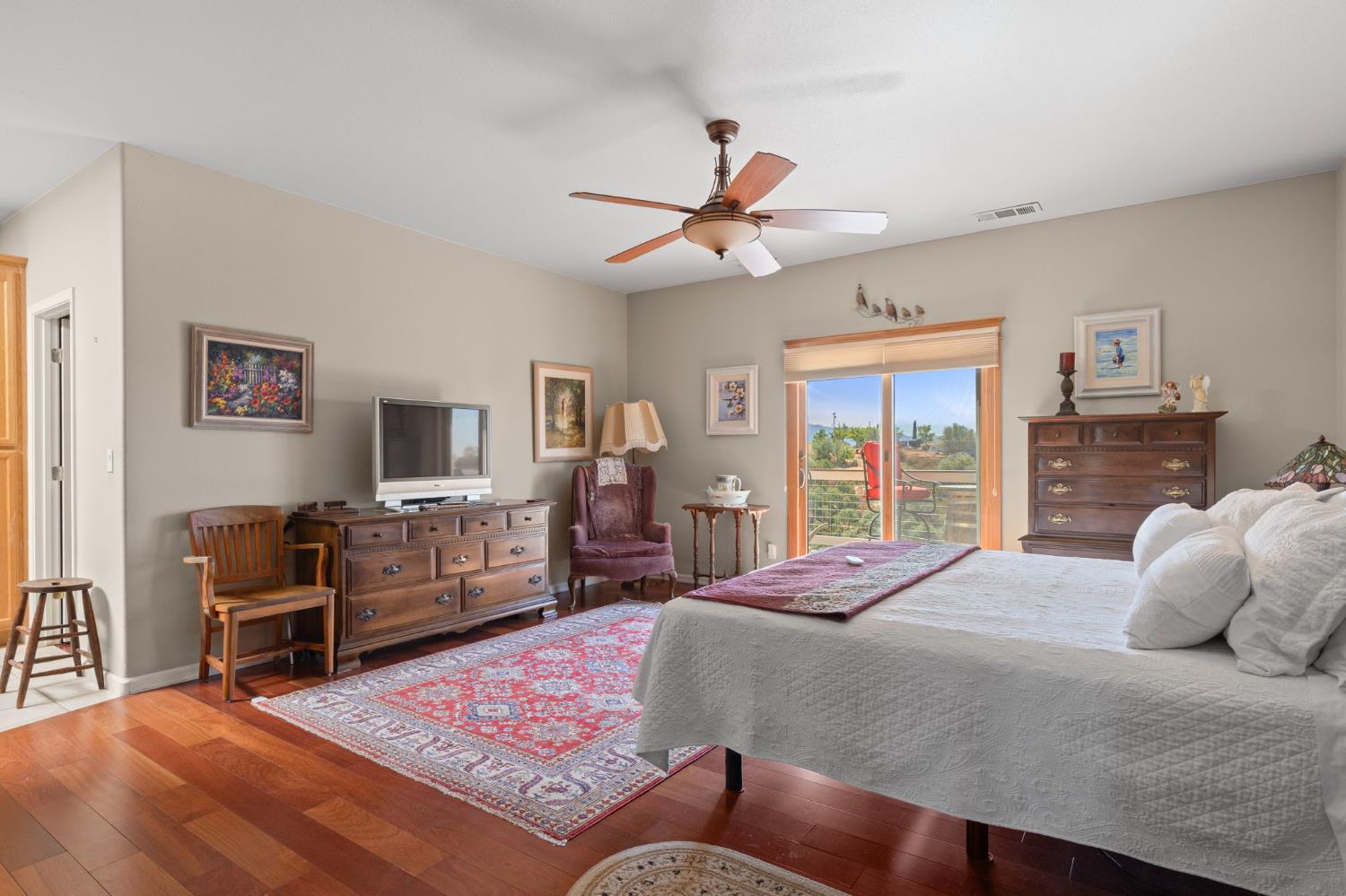 3235 Hagen Road Valley Springs, CA 95252 - Photo 20 of 40 a bedroom with a large bed a flat tv screen and dresser