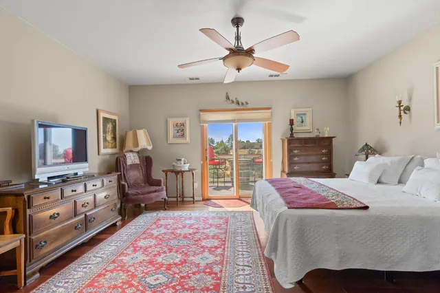 a bedroom with a large bed and a chandelier