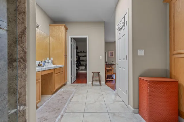 a large bathroom with a glass door shower and sink