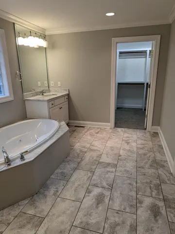 a bathroom with a sink a toilet and mirror