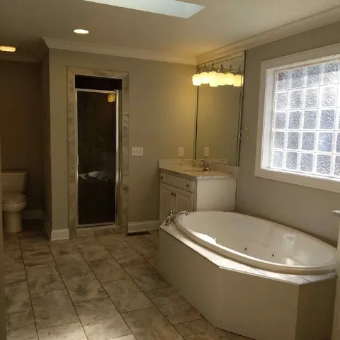 a bathroom with a tub and sink