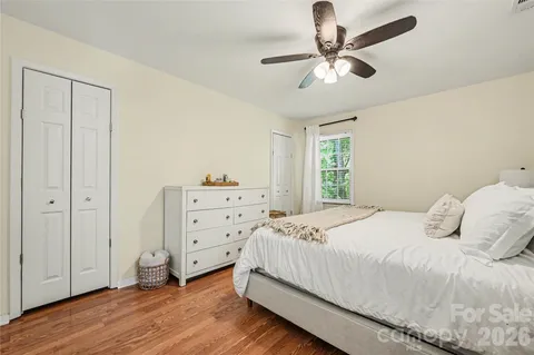 a bedroom with a bed and a ceiling fan