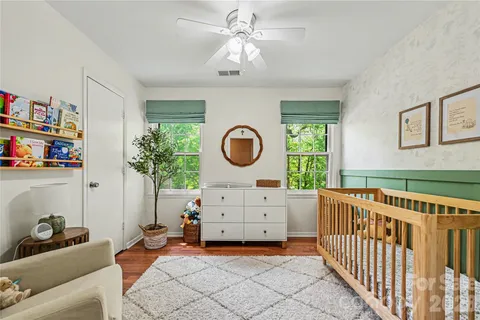a bedroom with furniture and a large window