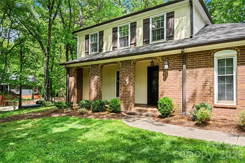 a front view of a house with a yard and outdoor seating