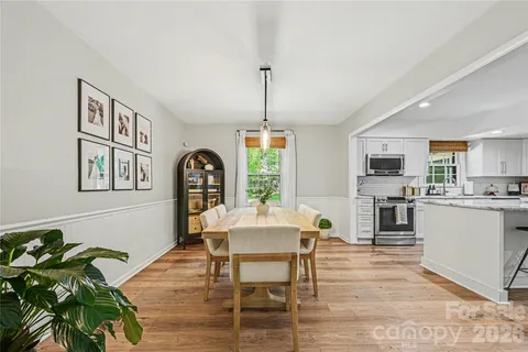 a dining room with furniture a window and a kitchen view