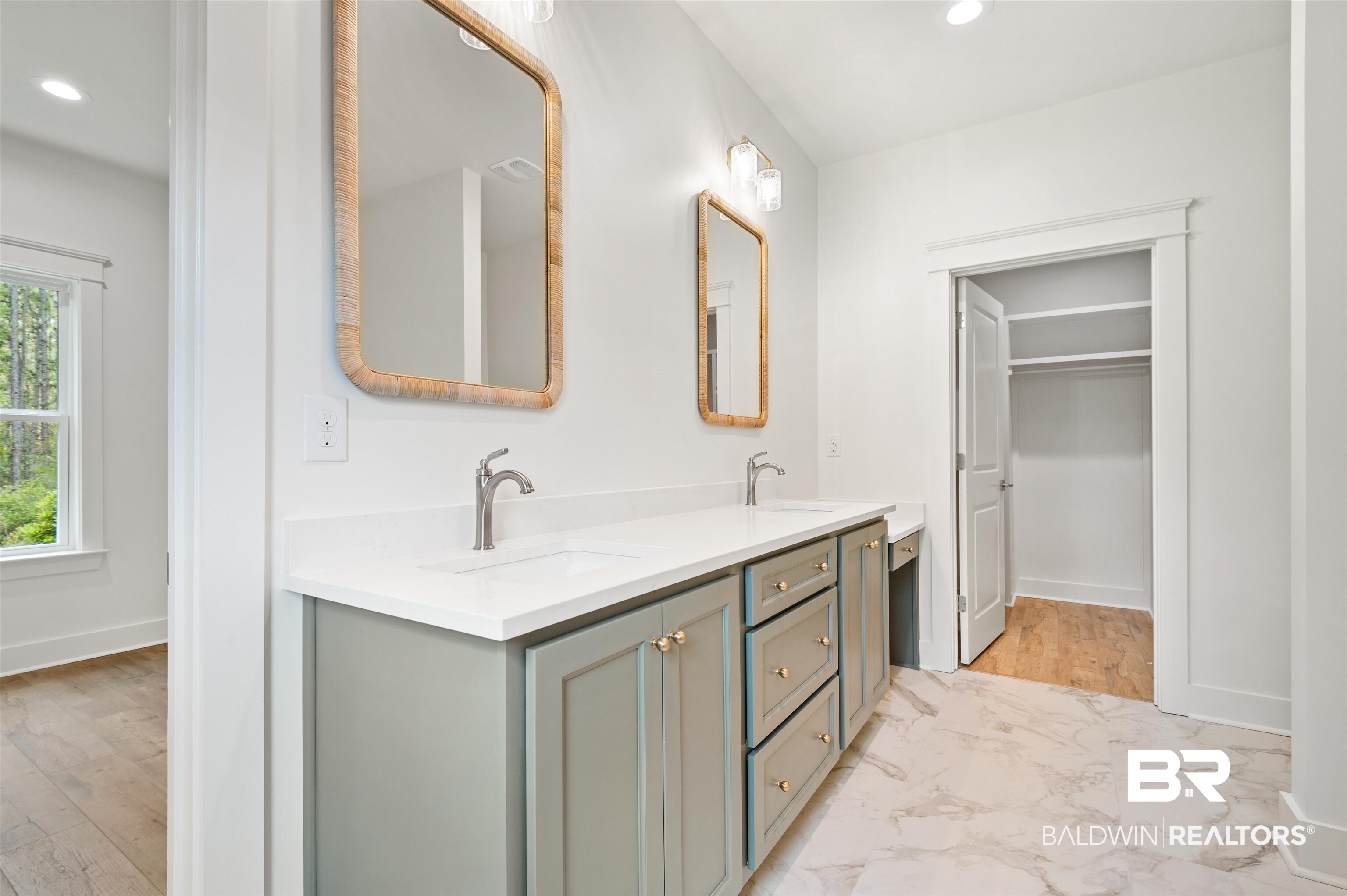 657 Island Way Gulf Shores, AL 36542 - Photo 19 of 59 Full bath with double vanity, recessed lighting, marble finish floors, and baseboards