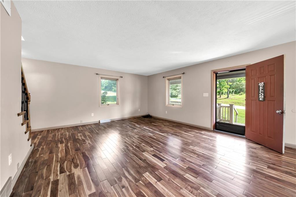 487 Ridge Road Hickory, PA 15340 - Photo 3 of 25 an empty room with wooden floor and windows