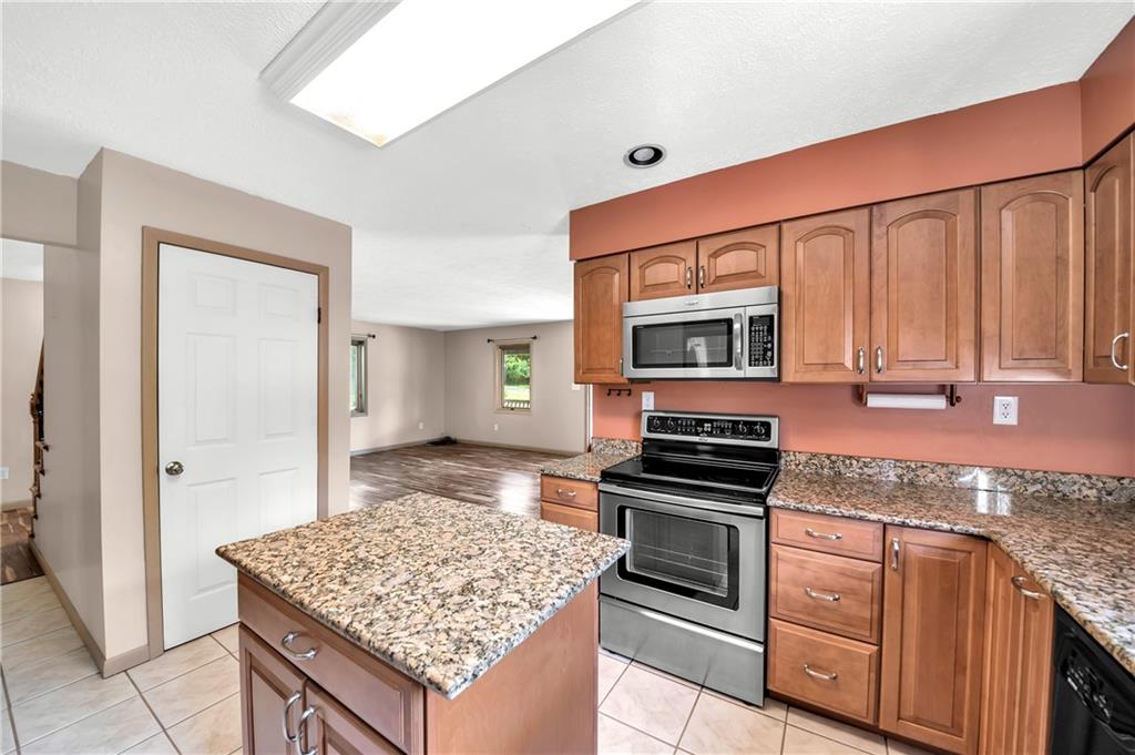 487 Ridge Road Hickory, PA 15340 - Photo 6 of 25 a kitchen with stainless steel appliances granite countertop a stove microwave and refrigerator