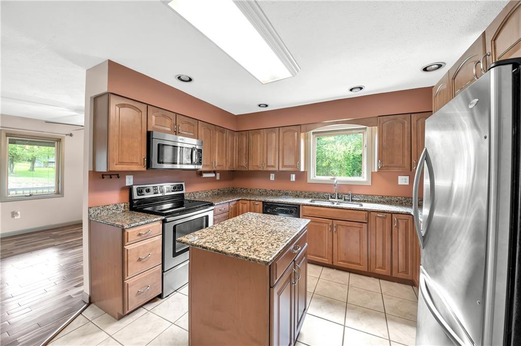 487 Ridge Road Hickory, PA 15340 - Photo 7 of 25 a kitchen with stainless steel appliances granite countertop a stove top oven a sink dishwasher and a refrigerator