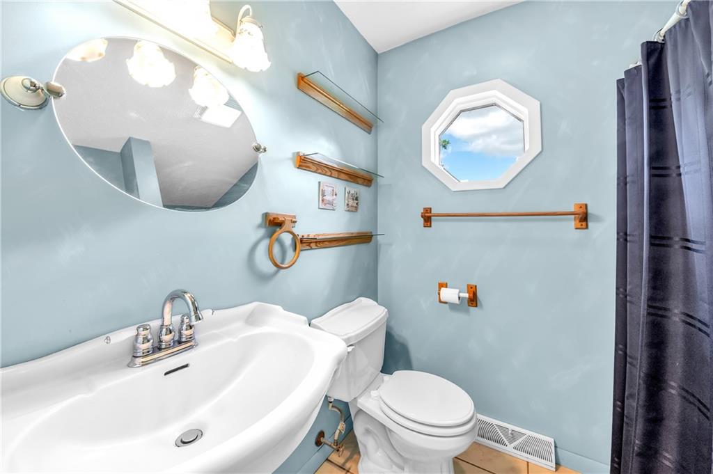 487 Ridge Road Hickory, PA 15340 - Photo 10 of 25 a bathroom with a sink mirror and toilet