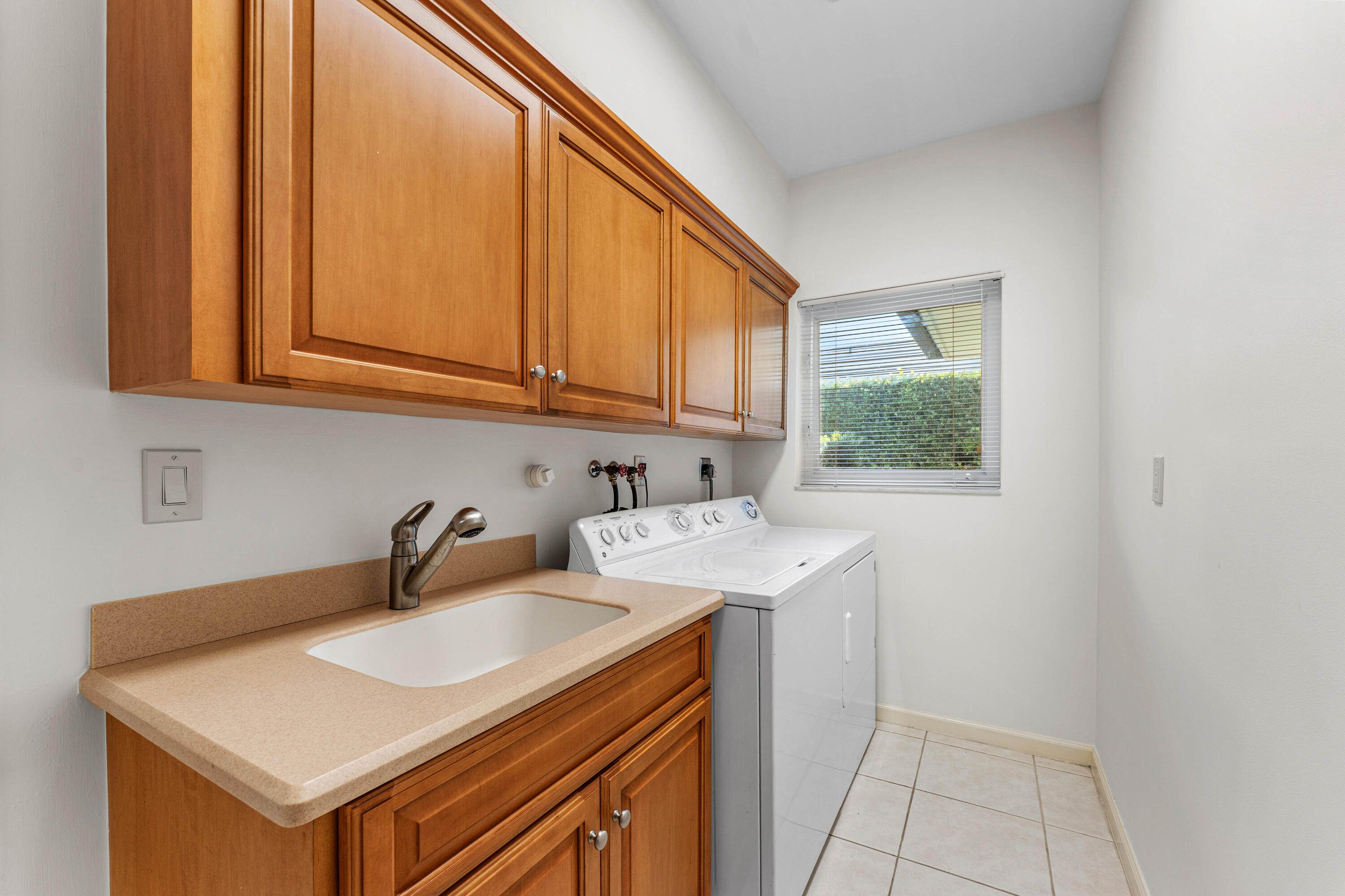 1851 Thatch Palm Drive Boca Raton, FL 33432 - Photo 30 of 70 a kitchen with a sink cabinets and a window