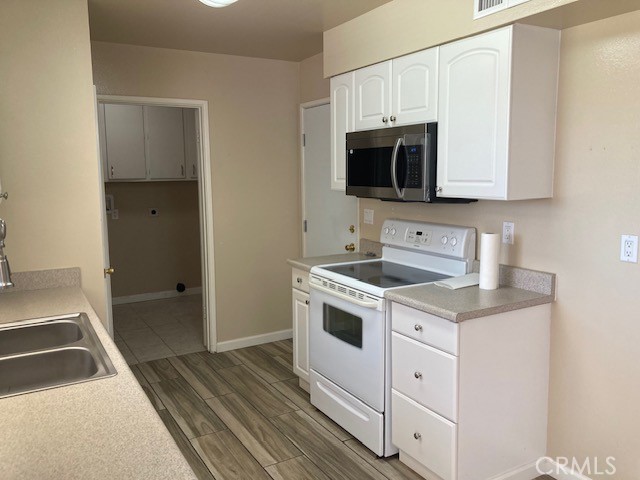 25801 McCall Boulevard Menifee, CA 92586 - Photo 12 of 15 a kitchen with a sink stove and microwave
