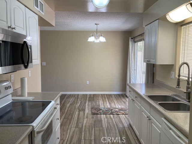 25801 McCall Boulevard Menifee, CA 92586 - Photo 15 of 15 a kitchen with wooden floor a sink and a stove top oven