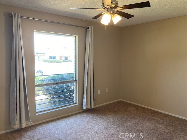25801 McCall Boulevard Menifee, CA 92586 - Photo 8 of 15 an empty room with a window and a ceiling fan