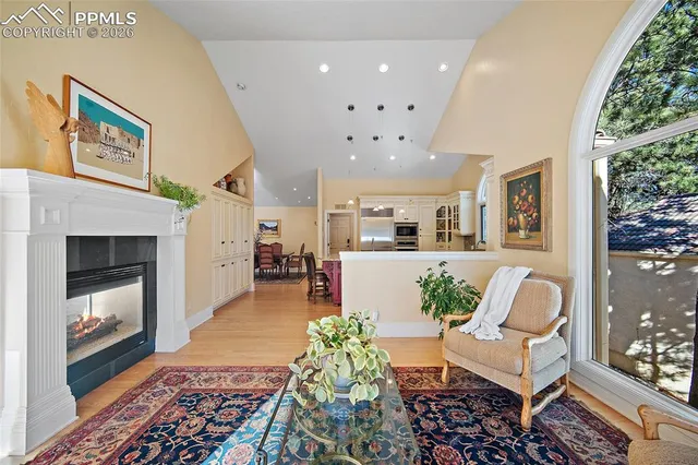 a living room with furniture fireplace and window