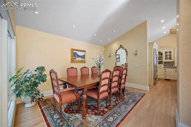 a dining room with furniture and wooden floor