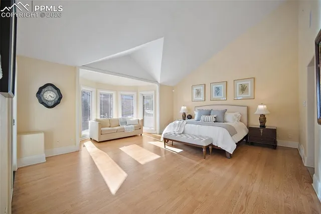 a spacious bedroom with a bed couch and a window