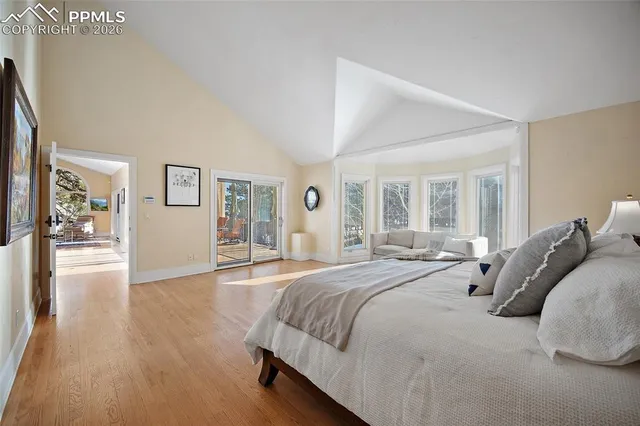 a spacious bedroom with a large bed and a large window