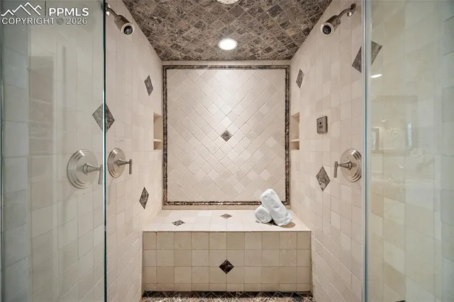 a bathroom with a sink mirror and shower
