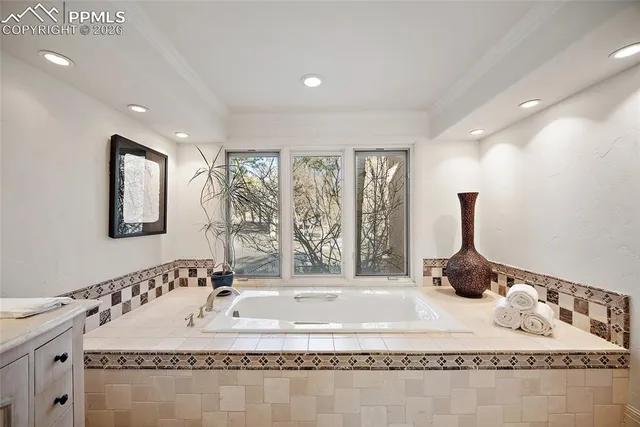 a bathroom with a granite countertop sink a mirror and shower