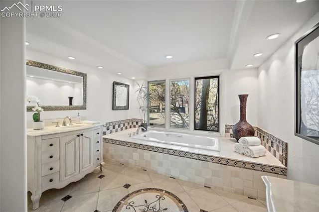 a large bathroom with double vanity and a mirror