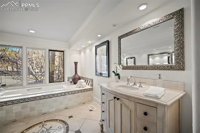 a bathroom with a sink mirror and a bath tub