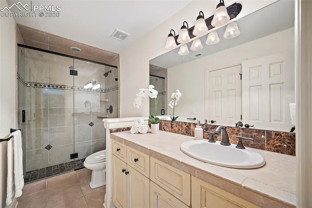 a bathroom with a double vanity sink mirror double and shower