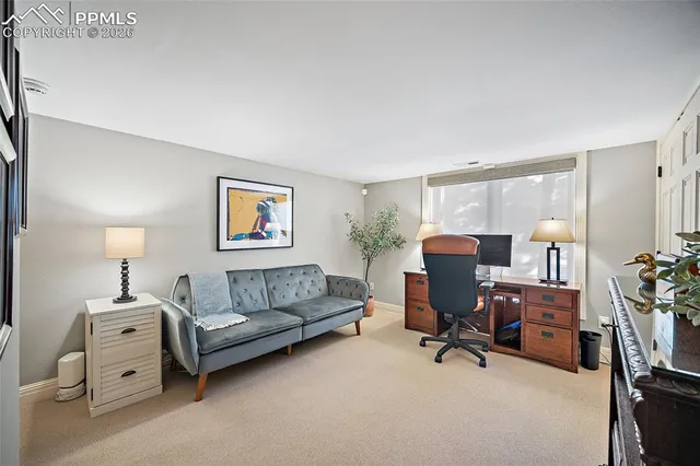 a living room with furniture and a work space