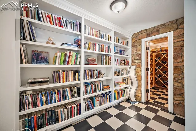 a living room with a book shelf and a book shelf