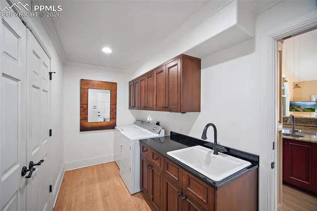 a kitchen with sink a faucet and cabinets