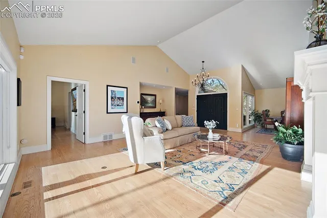 a living room with furniture a fireplace and a chandelier