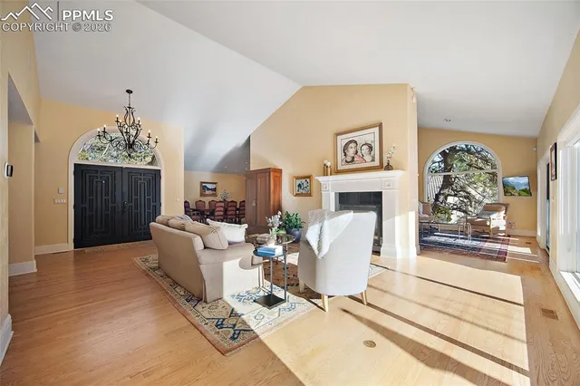 a living room with furniture a fireplace and a table