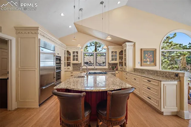 a kitchen with stainless steel appliances granite countertop a stove a refrigerator a oven and a refrigerator