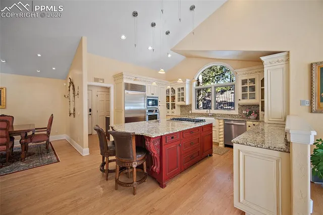 a large kitchen with a table and chairs in it