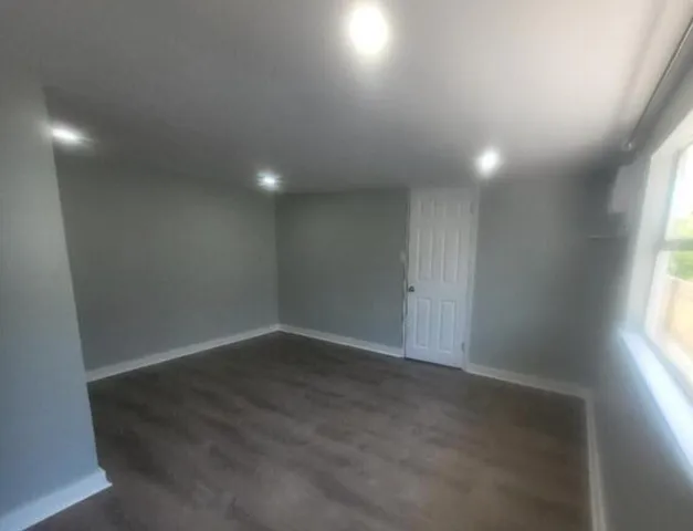 a white toilet sitting next to a shower